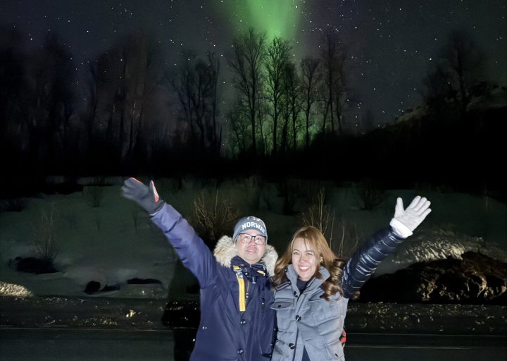 Two people happy to see the northern lights in the Tromso region